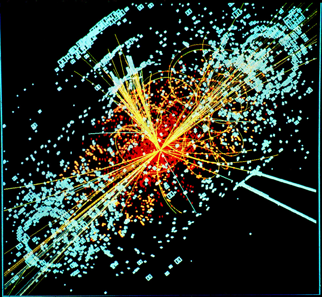 A particle collision recorded inside the CMS detector, sprays of tracks curling out from a single point.